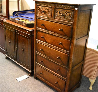 Lot 1079 - A 1920's oak sideboard, fitted with three slides, together with an oak tallboy (2)