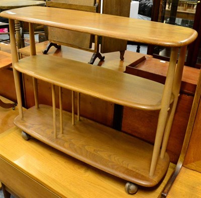 Lot 1092 - A 1960's/70's Ercol elm three tier tea trolley, labelled, 92cm by 32cm, 70.5cm high