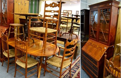 Lot 1093 - A reproduction yew wood glazed bureau bookcase together with, a similar pedestal dining table,...