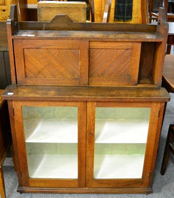 Lot 1101 - An Arts and Crafts glazed oak cupboard