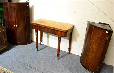 Lot 1104 - An oak bow fronted corner cupboard, a mahogany example and a mahogany fold over tea table