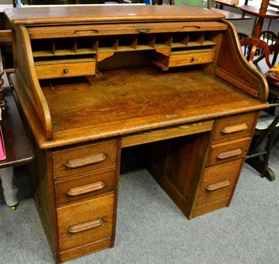 Lot 1117 - An Edwardian tambour door opening desk