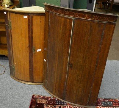 Lot 1125 - Two early 19th century oak and mahogany corner cupboards