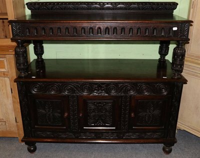 Lot 1221 - A carved oak buffet