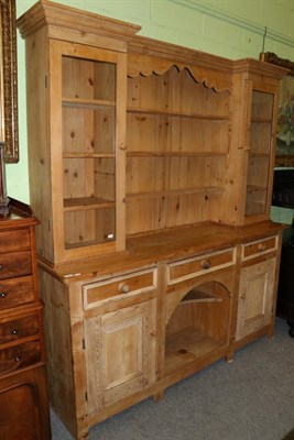 Lot 1222 - A pine dresser and rack, the rack with open shelves flanked by glazed cupboards, the base with...