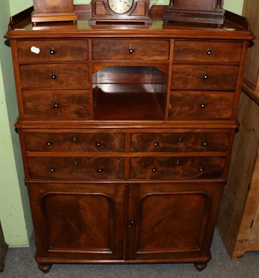 Lot 1223 - A Victorian mahogany cabinet, the tray top above an arrangement of drawers, surrounding a...