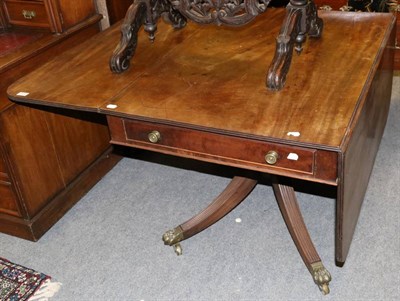 Lot 1237 - An early 19th century mahogany drop leaf table with a central single drawer, raised upon castor...