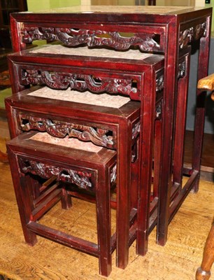 Lot 1241 - A nest of four marble topped Chinese hardwood tables