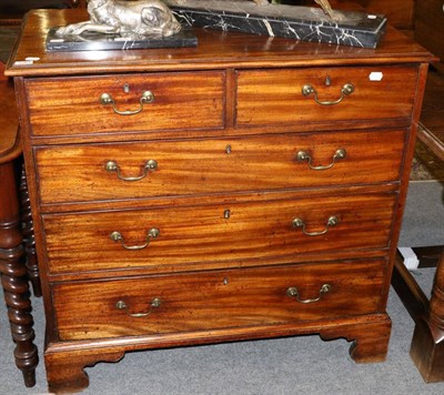 Lot 1261 - A George III mahogany chest of two short over three long drawers, bracket supports