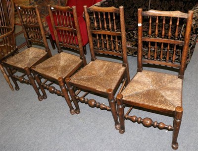 Lot 1269 - A set of four 19th century oak spindle back rush seated chairs