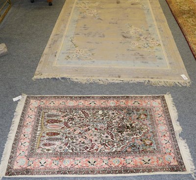 Lot 1281 - A Chinese rug, the field of semi naturalistic flowering plants enclosed by narrow borders, 245cm by