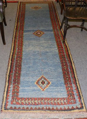 Lot 1289 - Gabbeh runner, South West Iran, the sky blue field with three stepped medallions framed by...