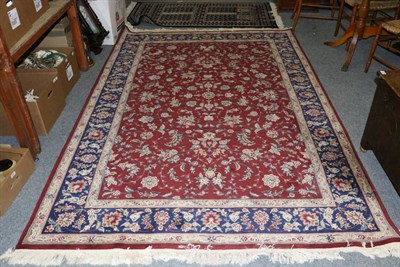 Lot 1301 - Chinese carpet, the pale aubergine field of scrolling vines enclosed by indigo floral borders,...