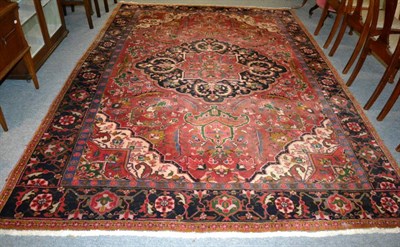 Lot 1302 - Heriz carpet, Iranian Azerbaijan, the raspberry field with indigo medallion framed by spandrels and