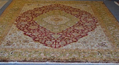 Lot 1305 - Agra design carpet, Indian, the raspberry field with vines around an olive green medallion...