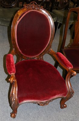 Lot 1318 - A carved and red upholstered armchair