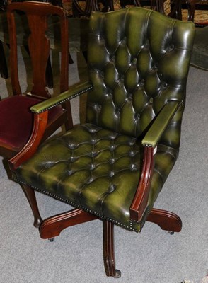 Lot 1320 - A reproduction green leather buttoned office chair