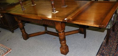 Lot 1329 - A reproduction oak draw-leaf dining table, labelled Chapmans & Co, Siesta House, Newcastle upon...