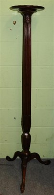 Lot 1359 - A mahogany torchere with reeded column and ball and claw feet