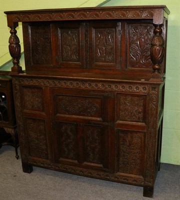 Lot 1361 - An ornately carved oak court cupboard