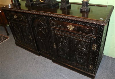 Lot 1369 - A large ornately carved oak sideboard