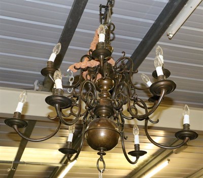 Lot 1371 - A brass Dutch style twelve light chandelier