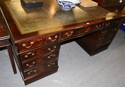 Lot 1376 - A reproduction mahogany twin pedestal partners desk with gilt tooled leather inset writing surface