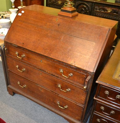 Lot 1378 - An early 19th century oak bureau