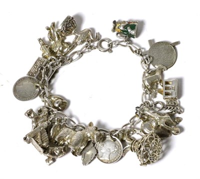 Lot 17 - A charm bracelet, with 23 various silver and white metal charms, including an enamelled Toby jug, a