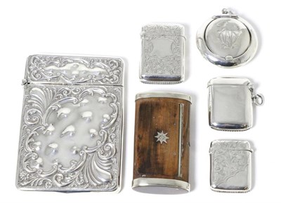 Lot 20 - A group of silver items comprising: a repousse decorated card case; three various vesta cases;...