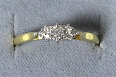 Lot 32 - An 18 carat gold diamond ring, a round brilliant cut diamond to diamond set shoulders, total...
