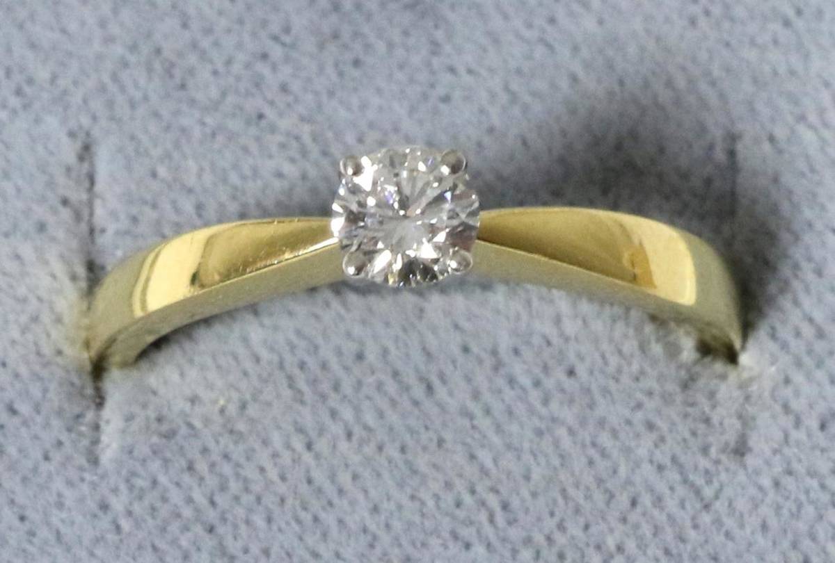 Lot 33 - An 18 carat gold solitaire diamond ring, a round brilliant cut diamond in a claw setting, to...