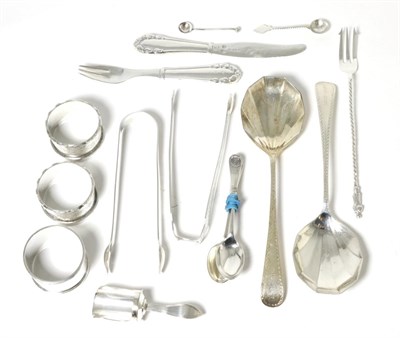Lot 38 - A mixed group of silver items including napkin rings; sugar tongs; Georg Jensen knife and fork;...