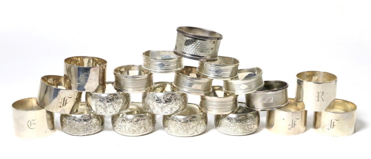 Lot 52 - A group of twenty assorted silver napkin rings; including a set of six with foliate engraving