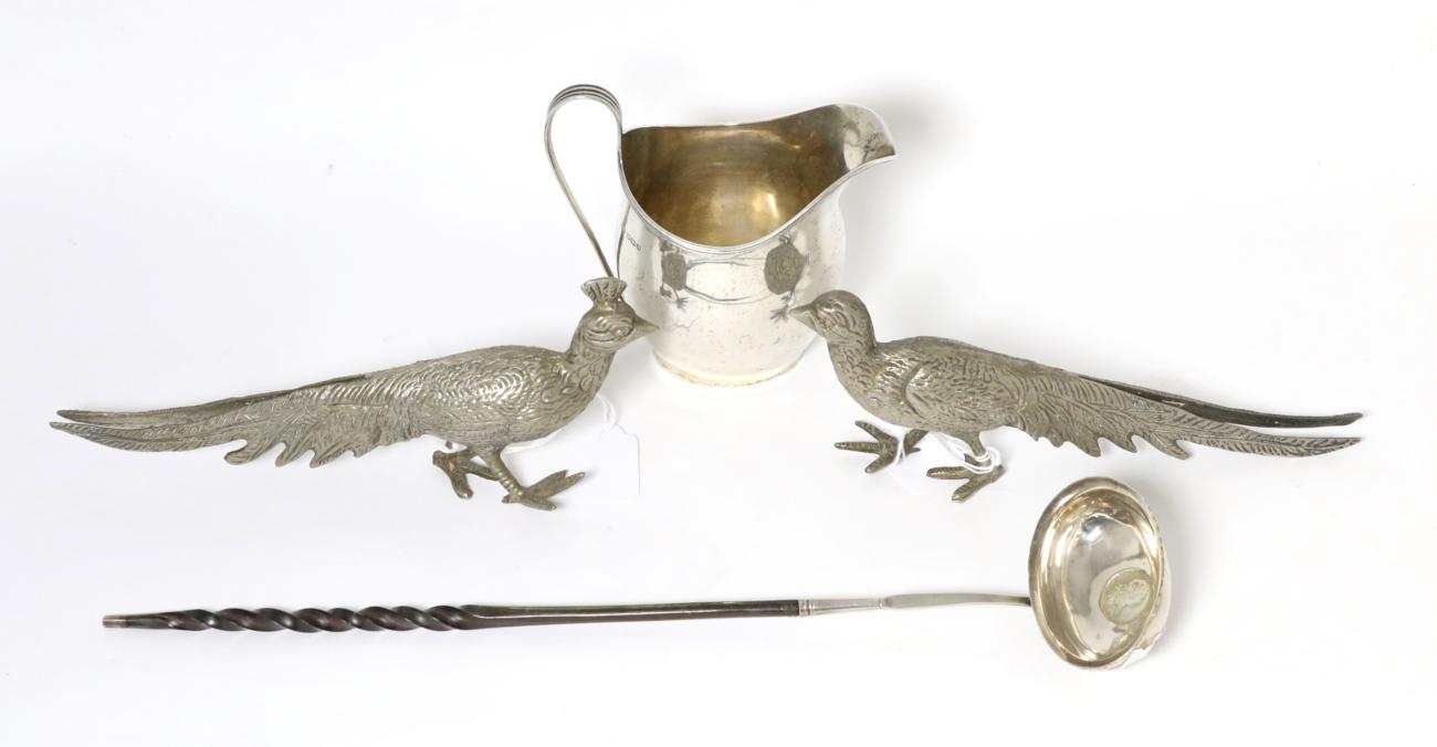 Lot 75 - A Georgian style silver cream jug, GH, Sheffield, 1930; together with a toddy ladle with inset...