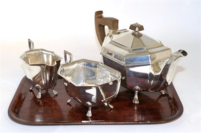 Lot 82 - An Art Deco silver three piece tea service, Viners Ltd, Sheffield 1940, octagonal form on paw feet