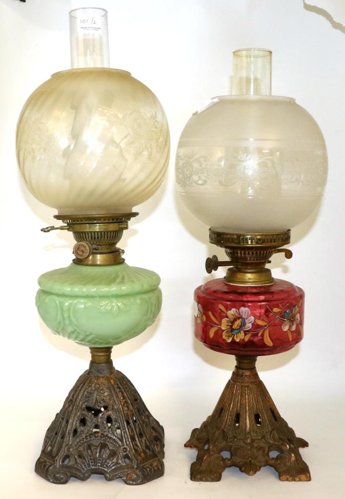 Lot 101 - Two Victorian oil lamps, one with a painted cranberry reservoir the other opaque green glass (2)