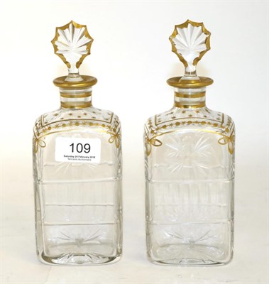Lot 109 - A pair of Daum cut glass decanters, with gilt decoration, gilt edged stoppers, signed Daum Cross of