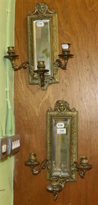 Lot 144 - A pair of brass mirrored triple light wall sconces