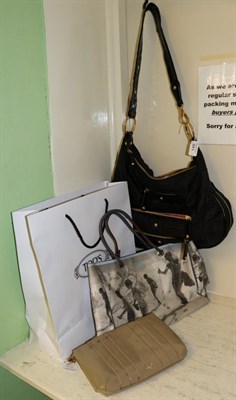 Lot 149 - Tod's black nylon shoulder bag with patent trim and strap and gold tone fittings, with dust bag; an