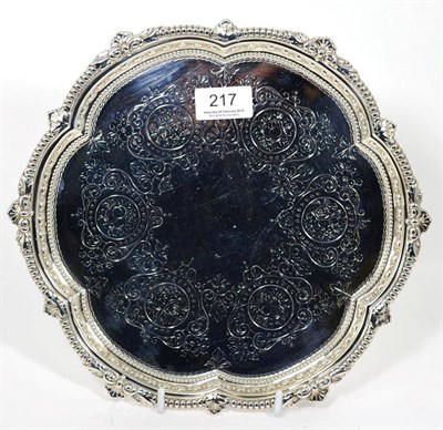 Lot 217 - A late Victorian silver salver, Mappin Bros, Sheffield 1899, shaped circular with folaite and...