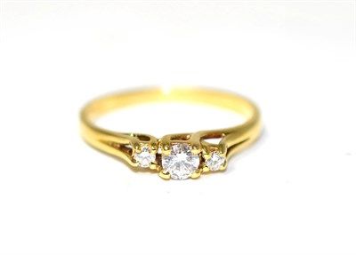 Lot 257 - An 18 carat gold diamond three stone ring, graduated round brilliant cut diamonds in claw settings