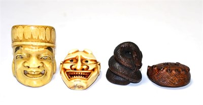 Lot 268 - Two Japanese Meiji period carved ivory netsukes in the form of masks together with two later wooden