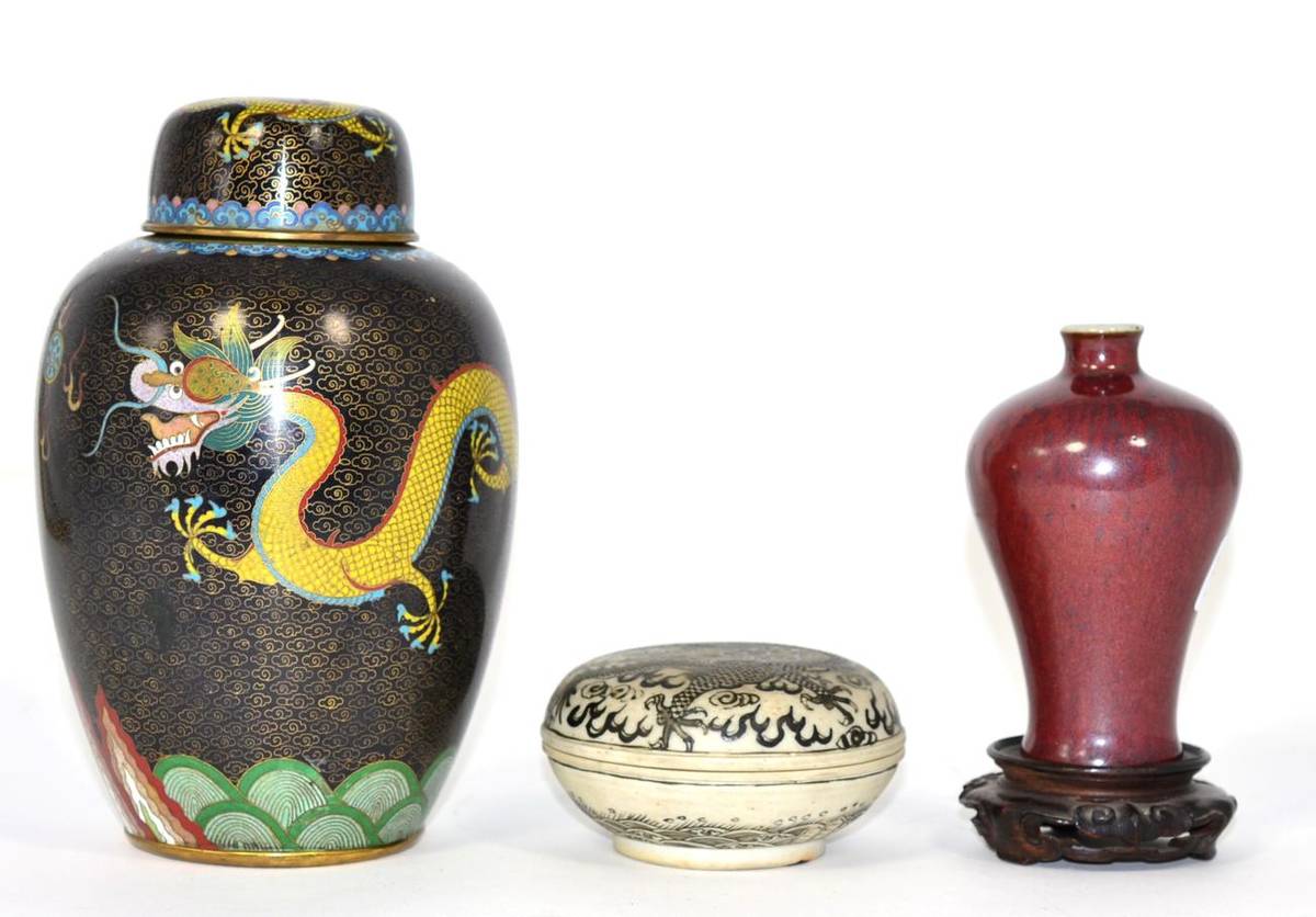 Lot 274 - A Chinese porcelain box and cover; a flambe glaze small baluster vase; and a cloisonne jar and...