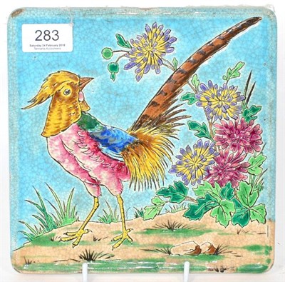 Lot 283 - An Arts & Crafts Longwy pottery tile decorated with an exotic pheasant with blue, yellow and...