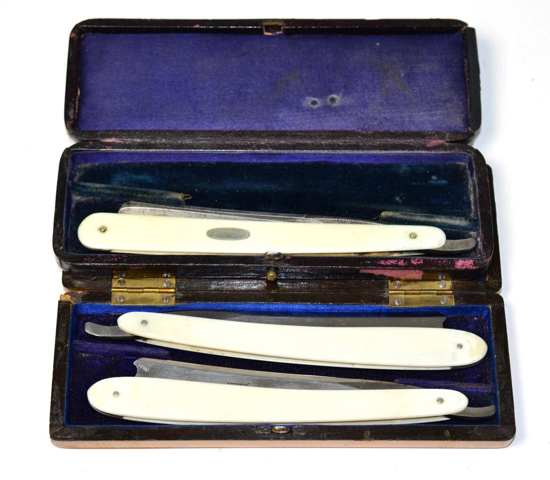 Lot 356 - A pair of Joseph Rodgers & Sons, Sheffield cut-throat razors with ivory handles, each blade...