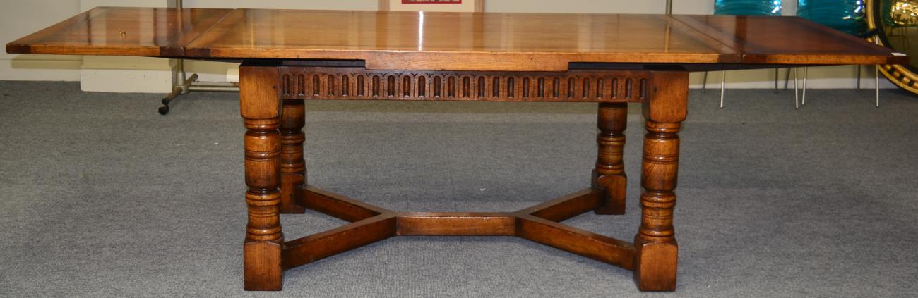 Lot 1010 - A Reproduction Oak Draw-Leaf Dining Table, labelled Chapmans & Co, Siesta House, Newcastle upon...