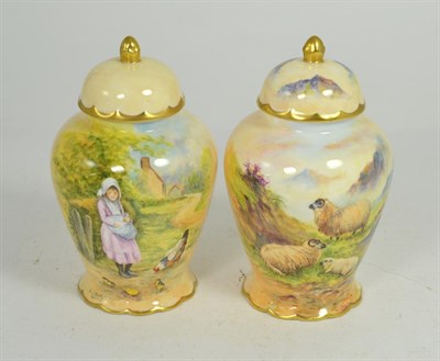 Lot 33 - A pair of hand painted vases and covers, one decorated with sheep in a landscape, another a...