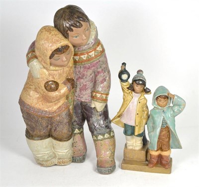 Lot 38 - A large Lladro figure of Eskimos, 39cm, together with a smaller Lladro figure group of a boy...