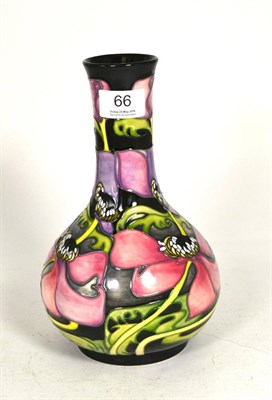 Lot 66 - A Moorcroft vase decorated with pink flowers on a black ground, second quality, by Emma...